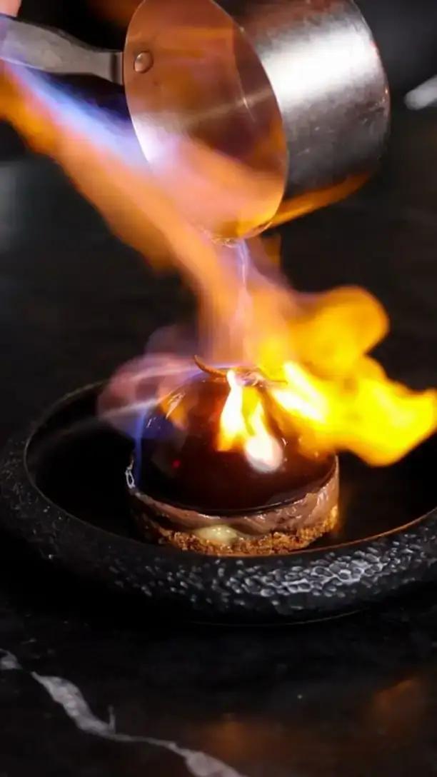 Flame poured over a dish at the table