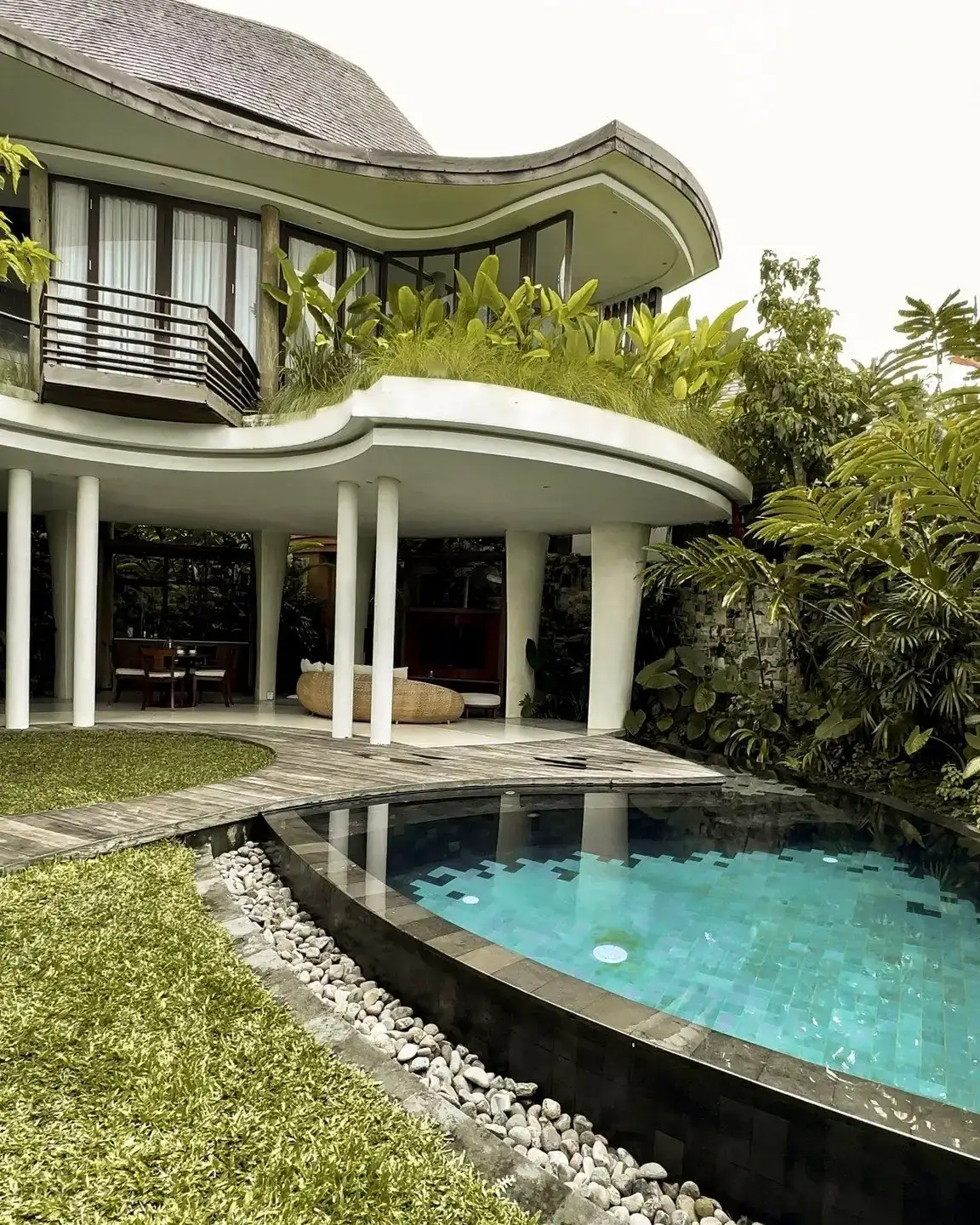 The villa exterior, curved roof above the swimming pool