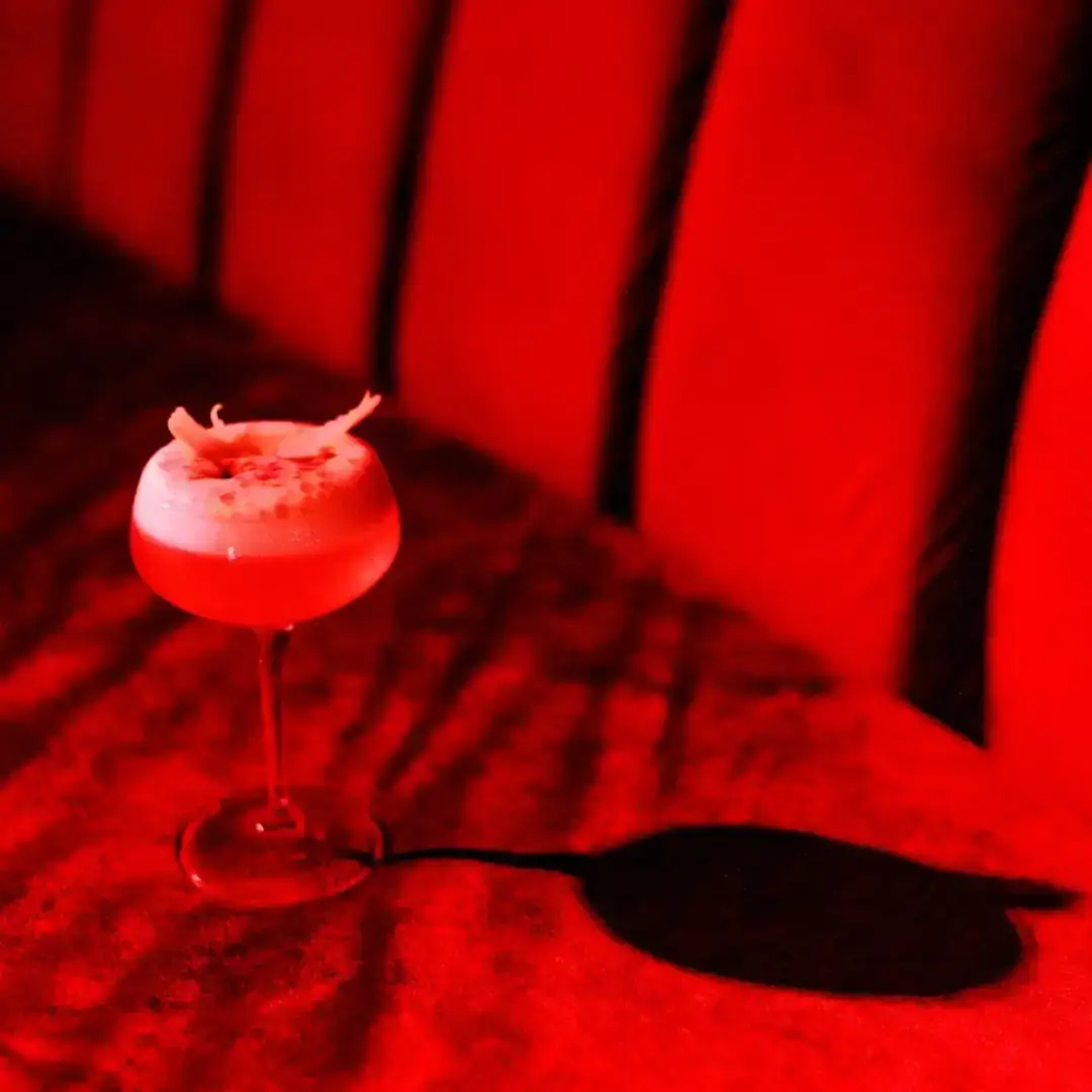 A blush cocktail on red velvet, then the MOYO floor